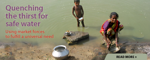 Woman and child drawing water from river with text 'Quenching the thirst for safe water: using market forces to fulfill a universal need'