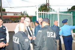 DEA Special Agent in Charge Javier F Peña and PRPD Superintendent Jose Figueroa are briefed on the progress of the operation by DEA supervisors.