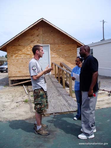 Pass Christian, MS - AmeriCorps St. Louis/Emergency Response Team leader Josh Smith counsels a couple in Pass Christian, Miss. about how to seek building permits and other assistance.