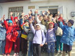 Photo of: Schoolchildren in the Romanian village Iana cheer after seeing the telecenter's new Internet connection in action.