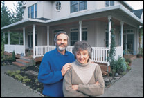 Couple standing in front of a house