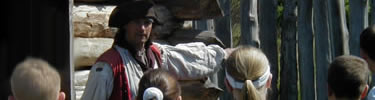 Costumed soldier talking with school children at Fort Necessity