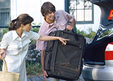 Man and woman loading their car with luggage