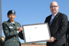 USCIS Director Emilio T. González presents Chief Warrant Officer Abida Shoyeb with the "Outstanding American by Choice" recognition in Baltimore, MD, Sept. 24, 2007