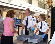 NDO TSO Bruce King and Supervisory TSO Kathleen Lorrie Maurer assist a passenger.
