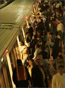 Photo of passengers getting on an off a metro train during rush hour