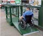 person in a wheelchair going up ramp and into the store
