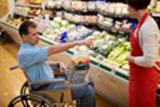 person in a wheelchair is in a store where aisles are wide enough to maneuver