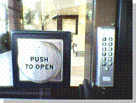 Photo of an accessible door, with extra large "Push to Open" button