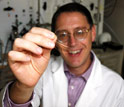 Benny Freeman of The University of Texas at Austin holds a sample of the new membrane.