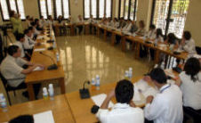 Photo of about 25 Youth Environment Parliament members and Member of Parliament Akhram Sheyhayb meeting around a large table at the Lebanese Parliament.