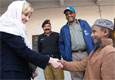 Peshawar, January 26, 2009 – U.S. Ambassador Anne W. Patterson shakes hands with a child recipient of the high nutrient biscuits provided to the Commission of Afghan Refugees by the U.S. government.