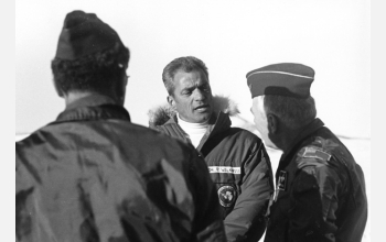 Peter Wilkniss (center) greets crew members of a C-5 transport plane near McMurdo.