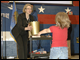 Secretary Margaret Spellings hands out the Golden Basket Award at Tinker Elementary School in Oklahoma City.