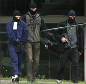 image of terror suspects in handcuffs.
