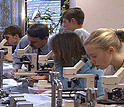 Photo of two boys, two girls and their teacher in science class