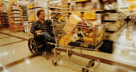 Image of man in wheelchair grocery shopping