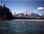 Photo of a lake side mountain peak