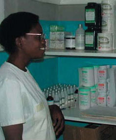 Photo: Mrs. Jessie Banda proudly displays the well-stocked supply room that contains life-saving medications in the Makungwa health center that serves 17,000 people.
