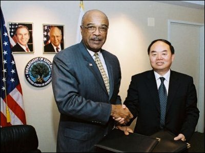 Secretary Paige and Zhou Ji, Vice Minister of Education of the People's Republic of China shake hands after signing the MOU to build an E-Language project.