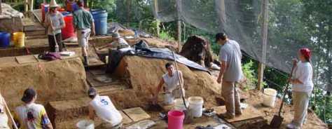 Large banner image of SEAC archeologists conducting fieldwork.