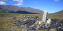 An Inuksuk stands out against the sky.