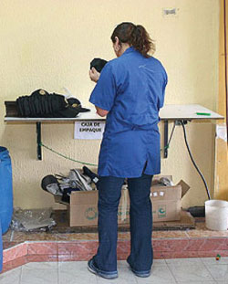 Tania, who now works for a clothing producer in Bogota, inspects baseball caps before they are packaged and sent to retail stores.