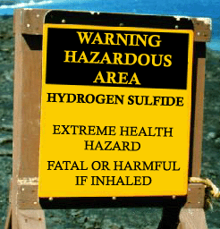 Fig. 1. Hydrogen sulfide warning sign: Warning Hazardous Area is in yellow letters on a black background. In black letters on a yellow background, the sign says Hydrogen Sulfide, Extreme Health Hazard, Fatal or Harmful if Inhaled.