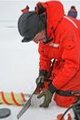Science: The image representing this topic is a photograph of a man in orange parka taking an ice sample from a glacier or icepack.