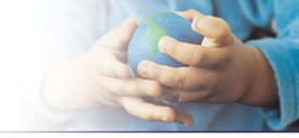 Photo of a child's hands holding a globe.