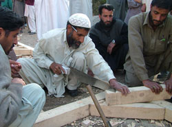 Mohammed Bashir, a carpenter from Kaleri village in Pakistan’s northeastern Bagh district, learns to make struts to support a wooden post for a house. He is among hundreds of craftsmen trained in earthquake-resistant construction by USAID.
