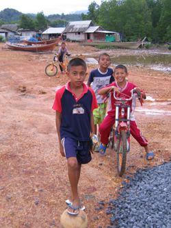 Elevated walkways in Kampuan village, Suk Samran district, keep children safe from unsanitary flood waters and help them get to school each morning, safe and dry.
