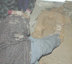 Women teach each other how to build better cooking stoves. The mud stoves designed in one village offer better protection from flames and more fuel-efficient cooking practices.