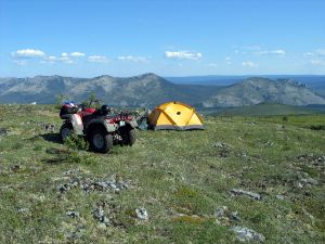 ATV at tent camp site.