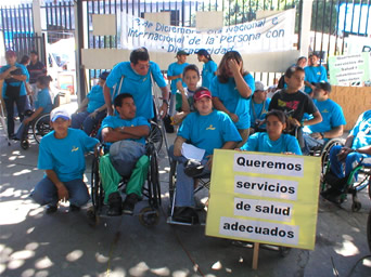 Photo of Members of the Cooperative Association of the Independent  Pro-Integral Rehabilitation Group, Ltd. (ACOGIPRI de  R.L.) hold a pacific demonstration at El Salvador Legislative Assembly in  support of a proposal to modify the Equivalent Opportunities for Handicapped  Persons Law, in December 2004.