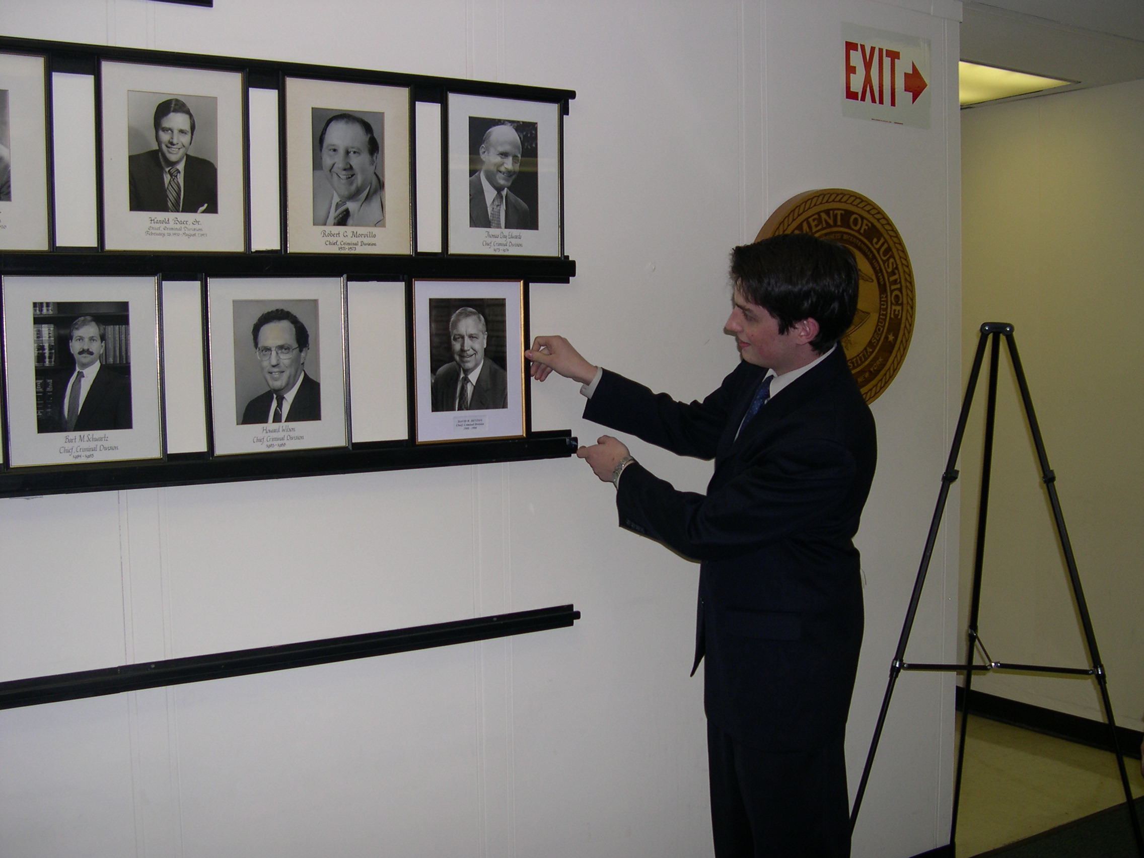 David Denton Jr. placing his father's portrait among the other previous Criminal Division Chiefs on May 14, 2007.