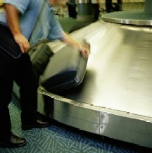 man claiming baggage at an airport
