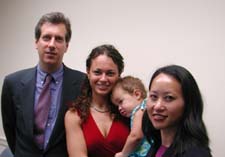 Charging Party Jennifer James (center) is pictured with her baby.  Standing next to her are EEOC Trial Attorney Kam Wong (right) and private counsel James A. Brown (left)