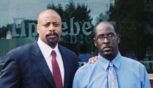 Charging Party Dwight Burch (right) is pictured in front of Applebee's with EEOC Atlanta Regional Attorney Robert Royal