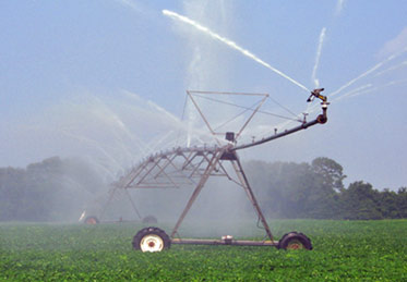 Farmland in Idaho being irrigated by a large spray-irrigation system. 