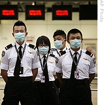 Contract staff of Port Health stand in attention before shifting duties at the Hong Kong Airport, 30 Apr 2009