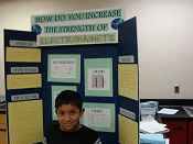 An Onalaska Middle School 7th grade student proudly stands by his display board at the Math and Science Expo.  (Photo by John Dudley)