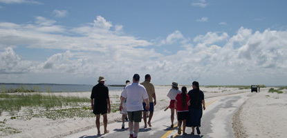 Visitors follow a ranger down the beach road at Perdido Key.