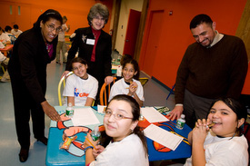 Children taking portion distortion quiz and eating healthy snacks