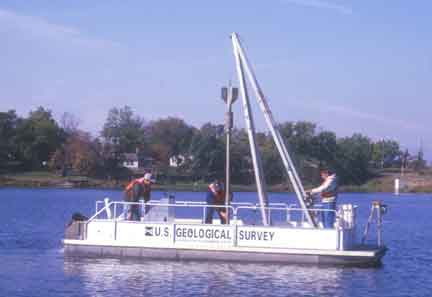 Photograph of a boat on 
lake doing sediment coring