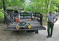 Maintenance Worker prepares to mow at Little Beaver Lake Campground.