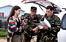 Image of army personel talking with civilian.