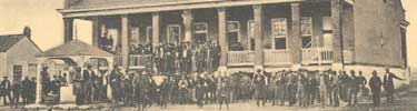 detail of postcard showing people in front of courthouse building