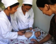 Photo of a family physician giving care to an infant in Turkmenistan.