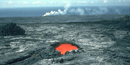Skylight reveals lava flowing to the ocean.
